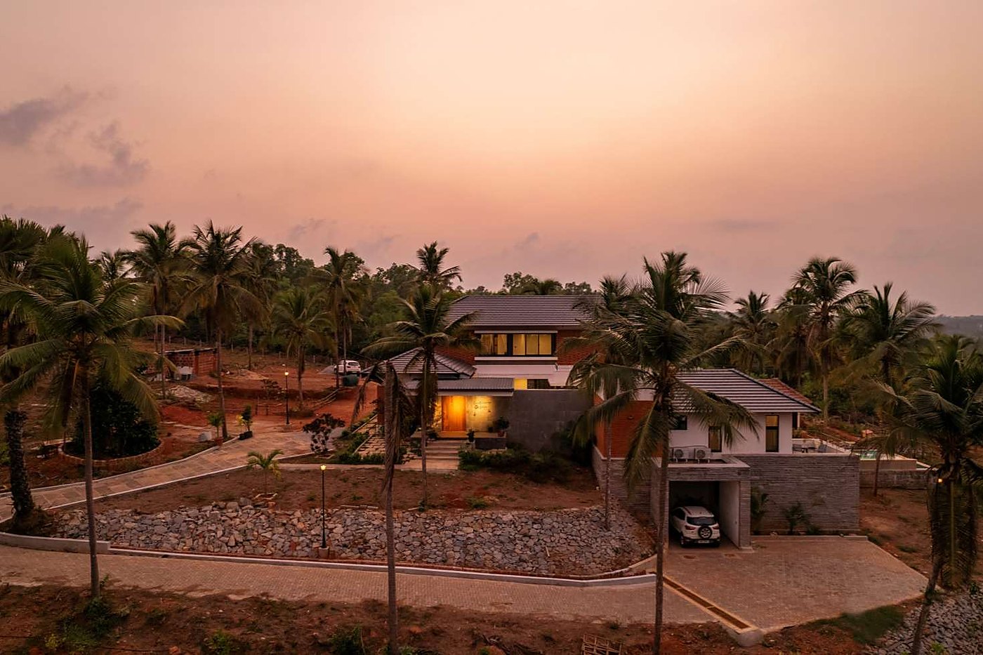 The Eternal Courtyard House by Dialogue Design Partners at dusk