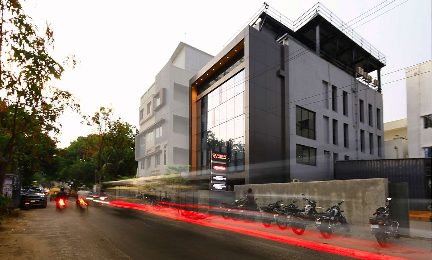 Street elevation of the office at dusk with light trails