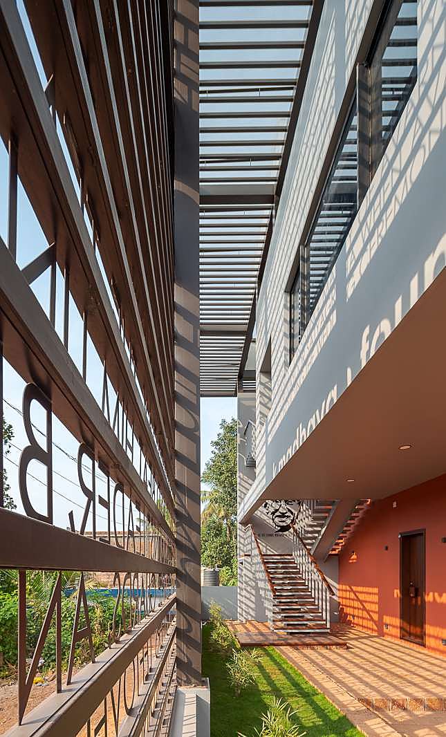 Side circulation court with lettered screen and pergola shadows