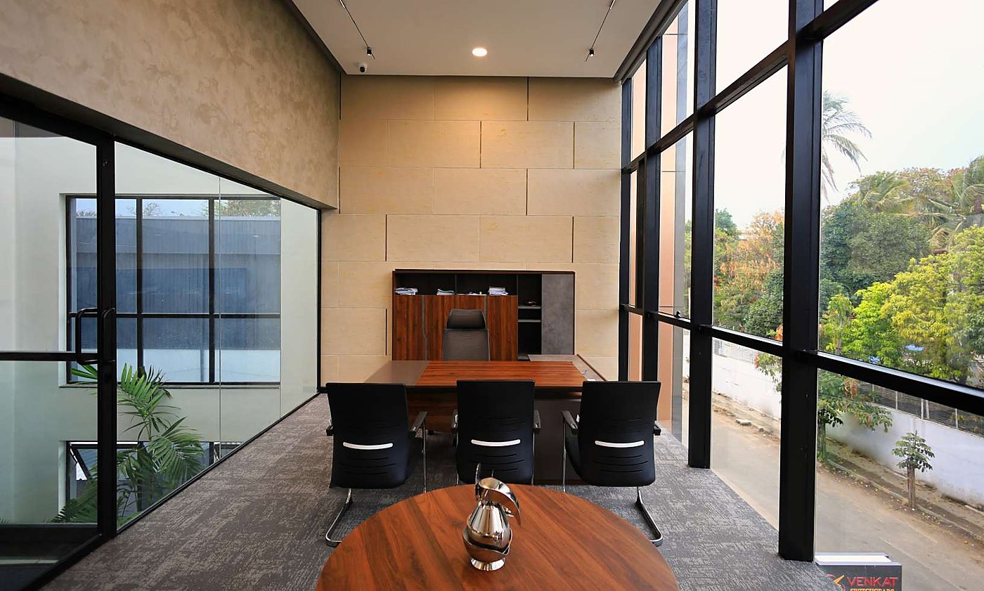 Executive cabin with stone wall and full-height glazing