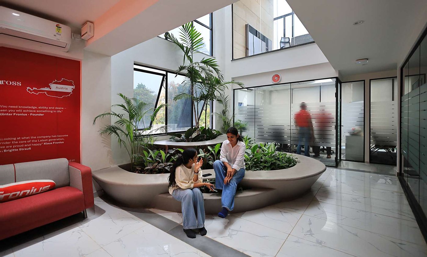 Central atrium with planted seating island and daylight above
