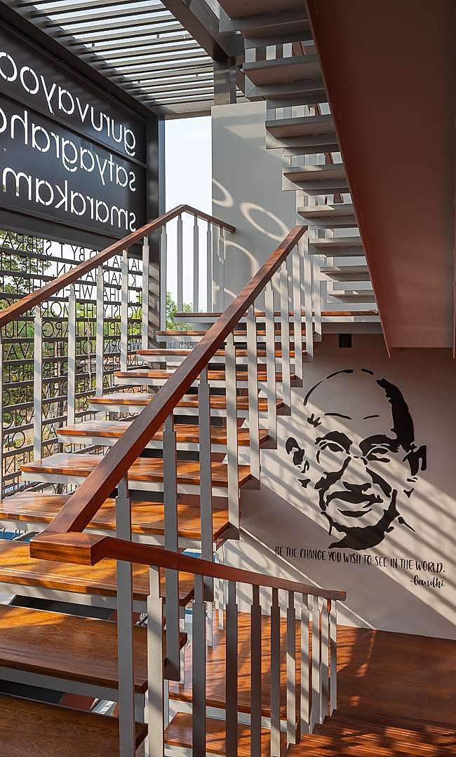 Timber stair with Gandhi mural and cut-out screen wall